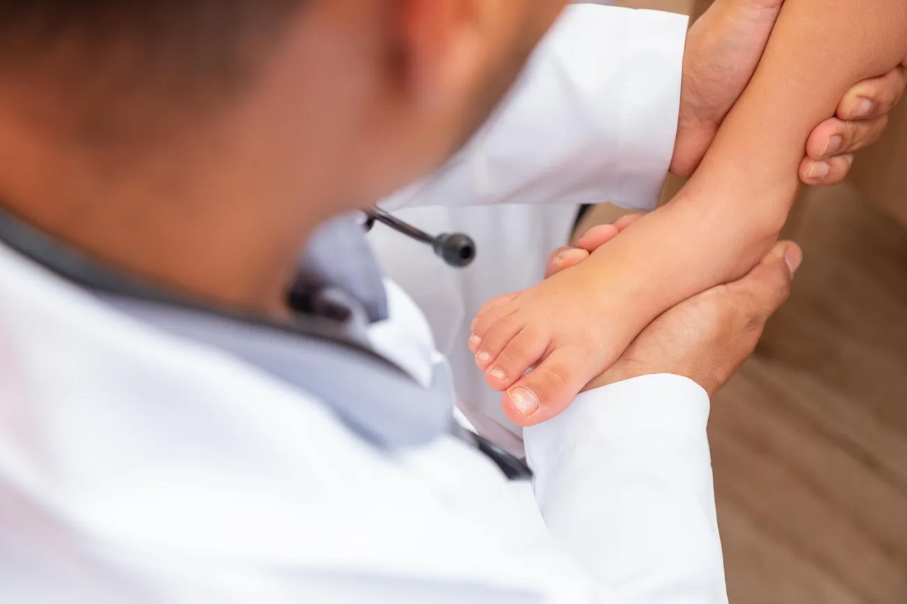 doctor examining children's feet