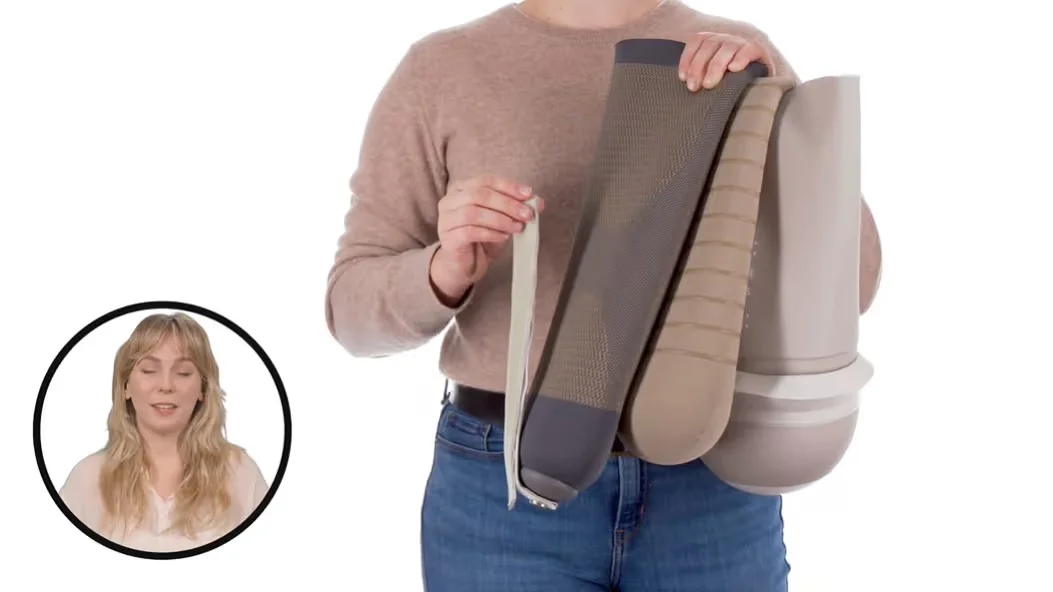 Person holding different types of beige and brown prosthetic liners against a white background.